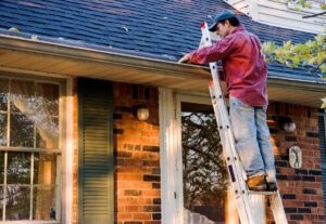 man cleaning gutter