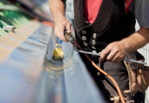 man welding gutter