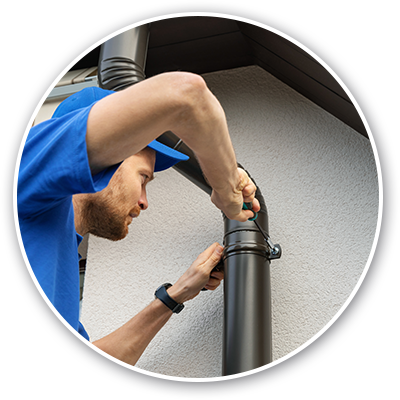 man installing seamless gutters