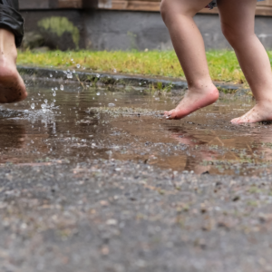 kids playing in a puddle