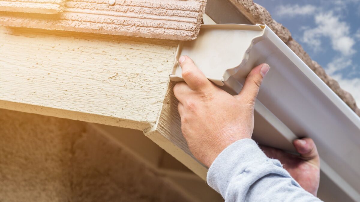 man installing gutters
