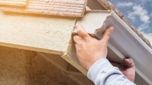 man installing gutters